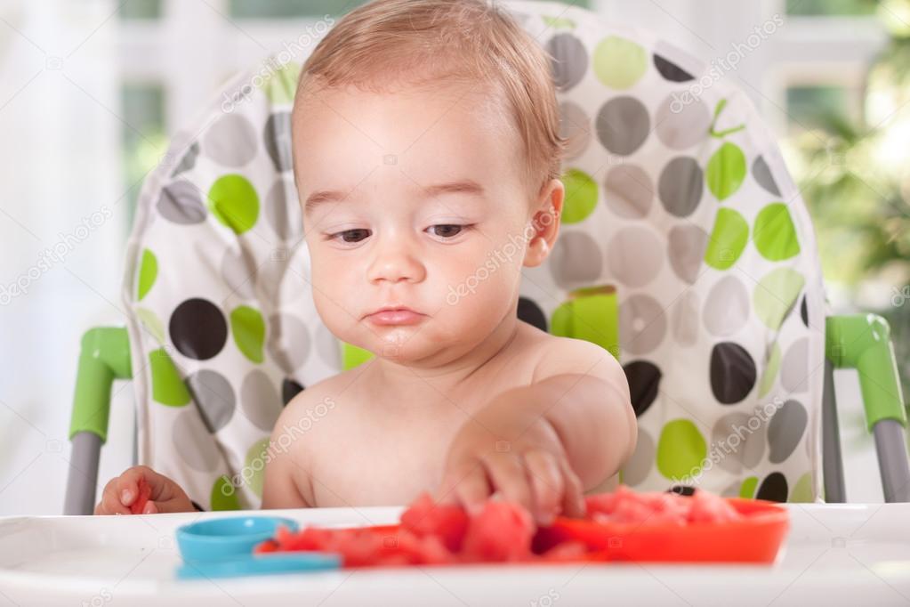 Baby eating watermelon with hands — Stock Photo © didesign 58139919