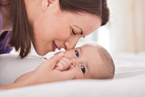 Young mother cuddling her gentle baby — Stock Photo, Image