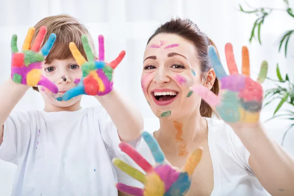 Happy smiling family with colorful hands — Stock Photo, Image