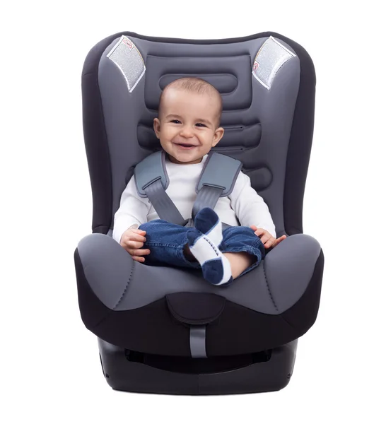 Улыбающийся младенец, сидящий в автомобильном кресле, изолированный на белом — стоковое фото