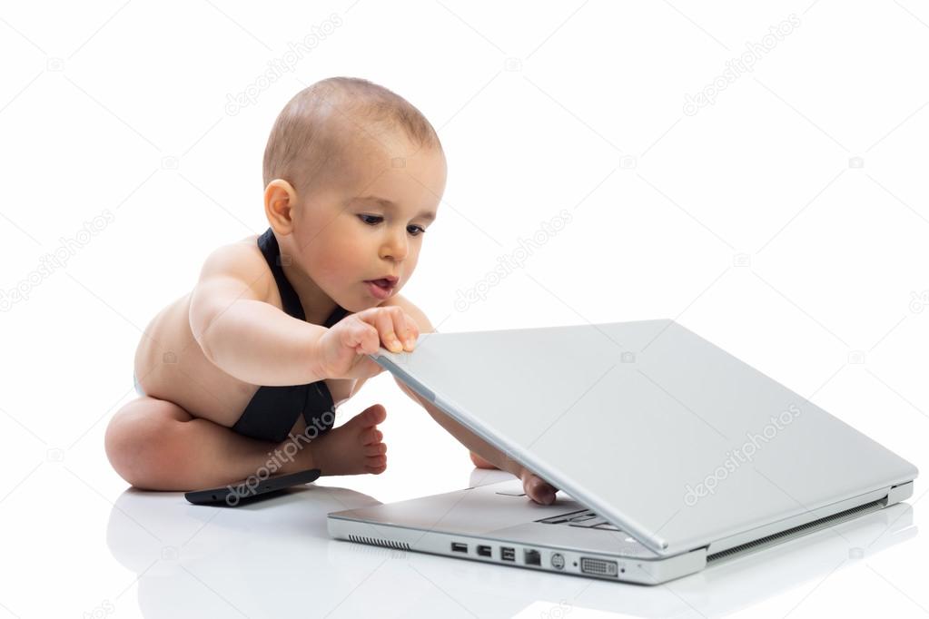 Baby child playing with computer