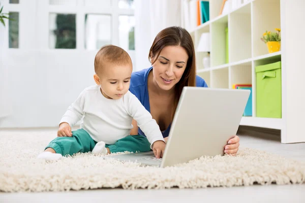 Happy smiling adorable family playing and shopping toys online — Stock Photo, Image