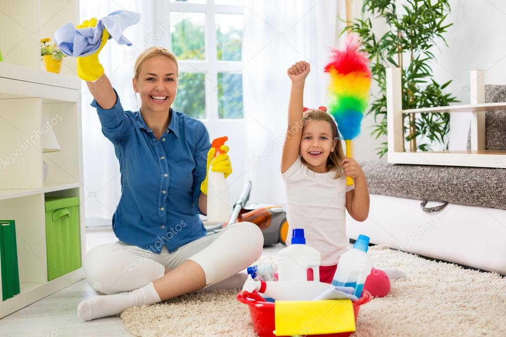 Little girl and mom cleaning room