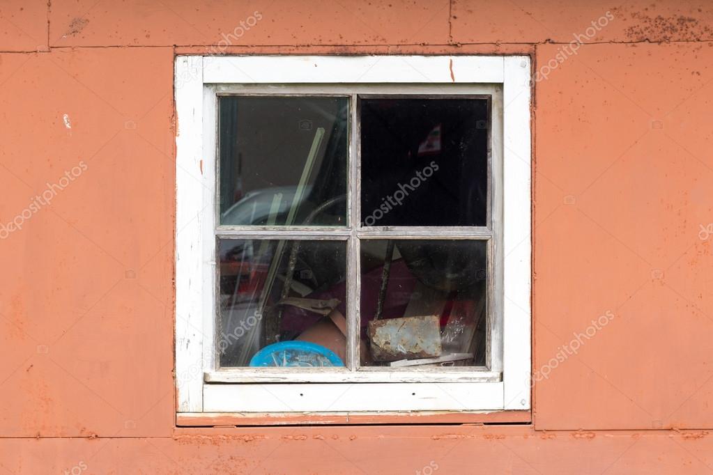 Rustic vintage window on red wall