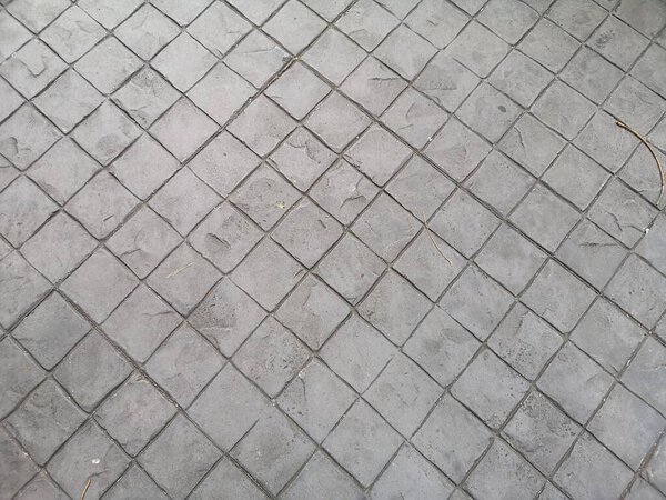 Stamp concrete black grey color hardener printing patterns on the cement or mortar surface block shape Square pattern material rough texture background