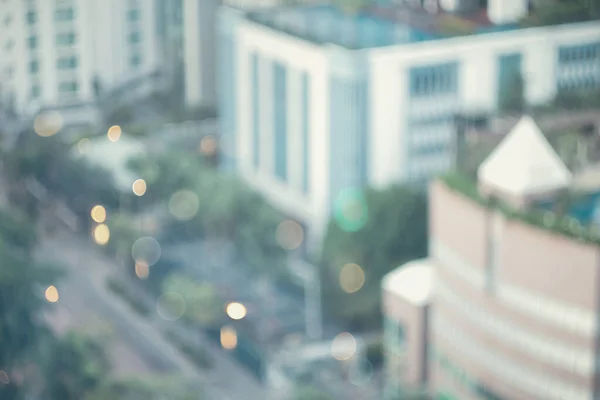 Abstract blur city estate building in morning view background. Cityscape skyline from top office window view. Blurred shine bokeh real architecture modern company construction town outdoor.