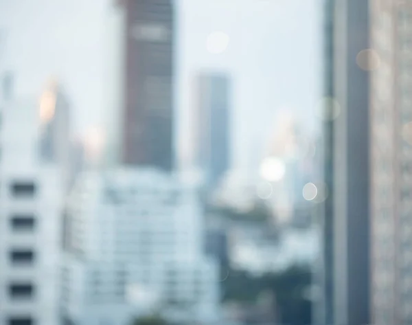 Abstract blur city estate building in morning view background. Cityscape skyline from top office window view. Blurred shine bokeh real architecture modern company construction town outdoor.