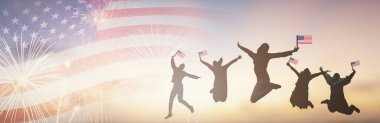 ABD Bayrağı 'nı tutan siluet grubu 4 Temmuz havai fişeklerini kutluyor. Sunset 'te mutlu Amerikan Bayrakları sallıyor. Bağımsızlık Gününü kutlayan kalabalık.