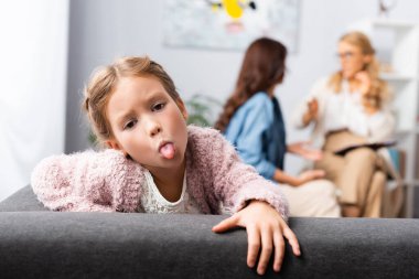 daughter fooling around while mother talking to psychologist clipart