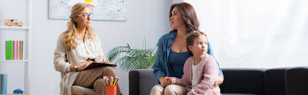 mother hugging daughter while visiting psychologist, banner