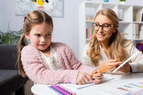 Displeased Little Patient Looking Digital Tablet While Visiting Psychologist — Stock Photo, Image