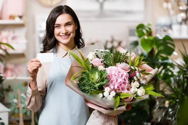 Alegre Florista Mirando Cámara Mientras Sostiene Ramo Tarjeta Visita Blanco — Foto de Stock