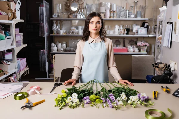 Young Florist Looking Camera Eustoma Flowers Secateurs Decorative Ribbon Rack — Stock Photo, Image