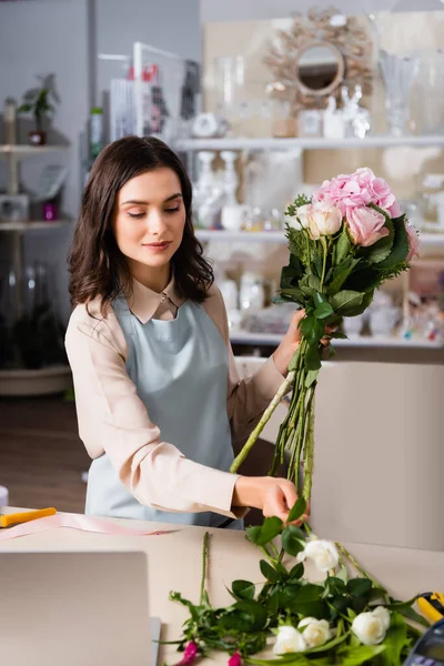 Positive Female Florist Taking Rose Desk While Arranging Bouquet Blurred — Stock Photo, Image
