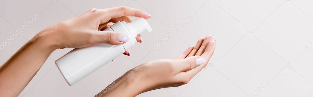 cropped view of woman applying cleansing foam isolated on grey, banner