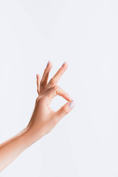 cropped view of woman showing ok isolated on white