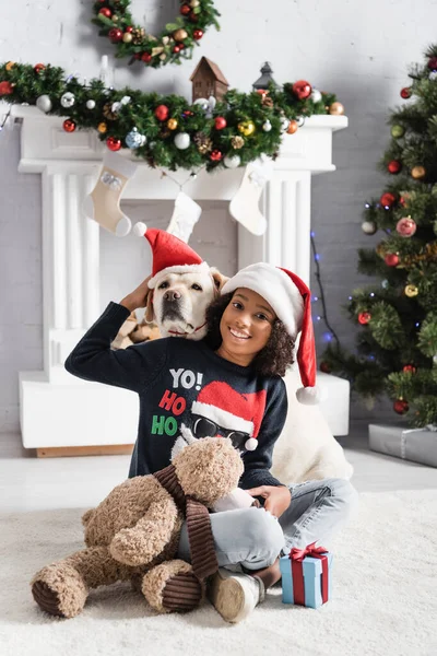 Happy African American Girl Sitting Floor Teddy Bear Hugging Labrador — Stock Photo, Image