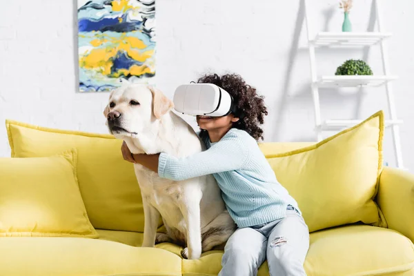 Smiling African American Girl Headset Embracing Dog While Sitting Yellow — Stock Photo, Image