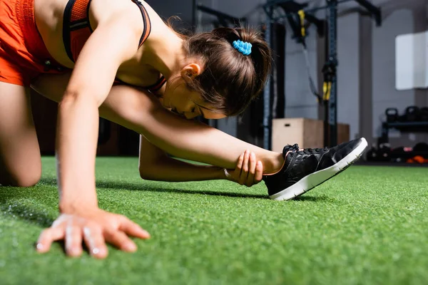 Young Sportswoman Reaching Leg Head While Stretching Sports Center Blurred — Stock Photo, Image