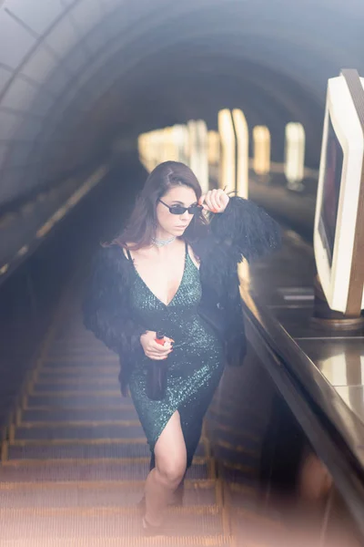 Glamour Woman Black Dress Holding Wine Bottle Looking Away Escalator — Stock Photo, Image