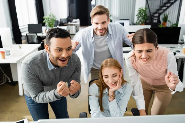 Excited Multicultural Businesspeople Looking Computer Blurred Foreground Office — Stock Photo, Image