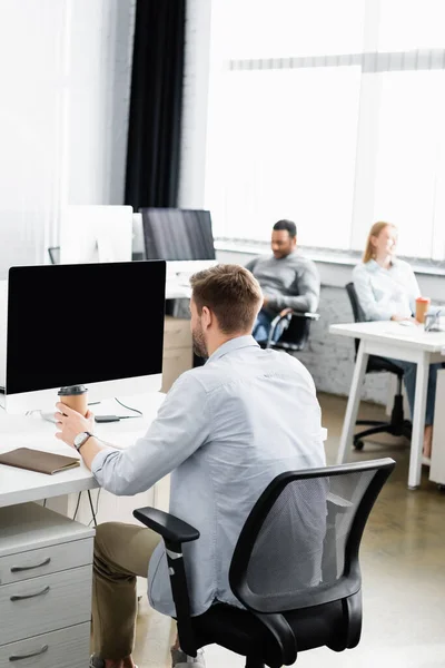 Businessman Holding Coffee Computer Colleagues Blurred Background — Stock Photo, Image