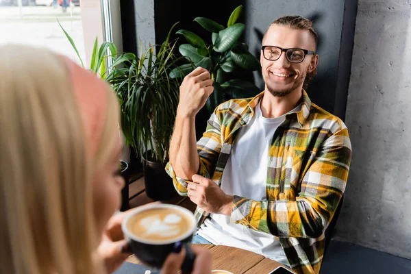 Smiling Young Man Eyeglasses Looking Woman Holding Cup Coffee Blurred — Stock Photo, Image