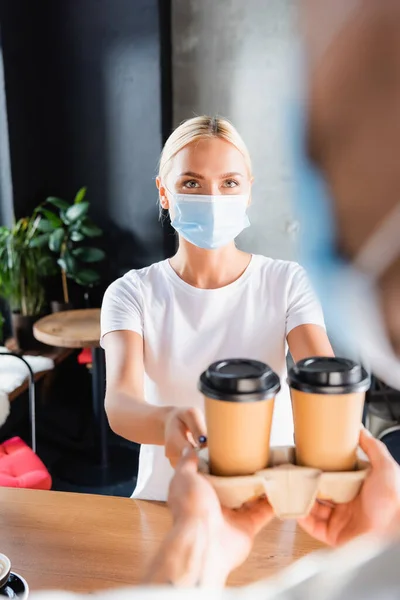 Young Blonde Woman Medical Mask Taking Coffee Waiter Blurred Foreground — Stock Photo, Image