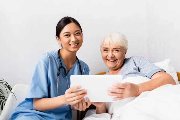 Happy Asian Nurse Laughing Senior Woman Looking Camera While Holding — Stock Photo, Image