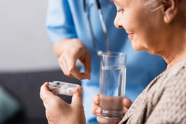 Sjuksköterska Pekar Med Fingret Piller Handen Äldre Kvinna Som Håller — Stockfoto