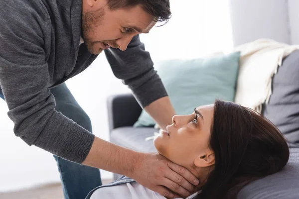 Aggressive Man Choking Wife Bruises Face Couch Home — Stock Photo, Image