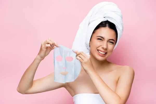 Disgusted Beautiful Woman Towel Head Holding Mask Sheet Isolated Pink — Stock Photo, Image