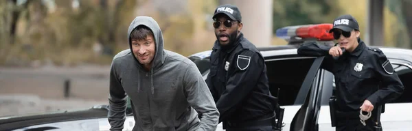 Hooded Offender Running Shocked Multicultural Police Officers Blurred Background Outdoors — Stock Photo, Image