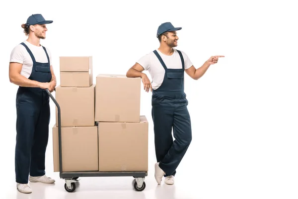 Full Length Happy Indian Mover Uniform Cap Pointing Finger While — Stock Photo, Image