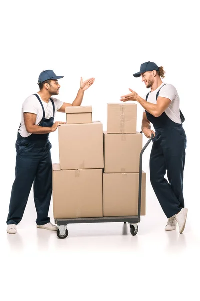 Full Length Multicultural Movers Uniform Caps Pointing Hands Each Other — Stock Photo, Image