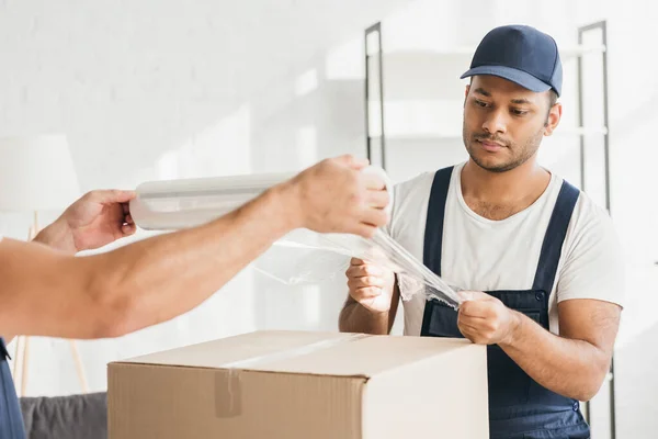 Multicultural Movers Overalls Wrapping Box Stretch Film — Stock Photo, Image