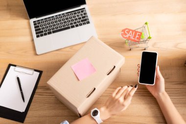 Gönüllülerin elinde boş ekranlı akıllı telefon, karton pano ve satılık alışveriş arabasının olduğu en iyi manzara. 