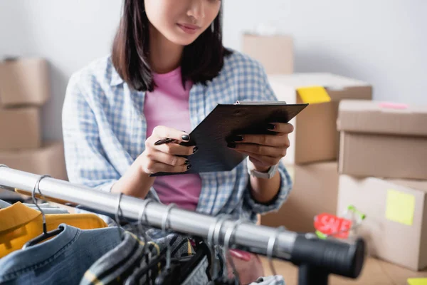 Cropped View Volunteer Holding Pen Clipboard Clothes Hanging Rack Boxes — Stock Photo, Image