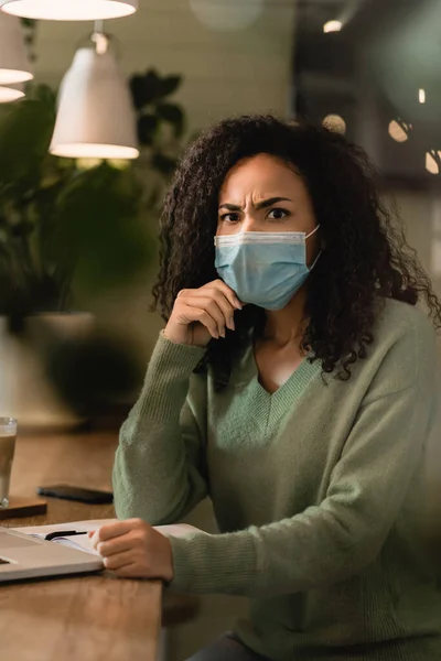 Dissatisfied African American Woman Medical Mask Looking Camera Cafe — Stock Photo, Image