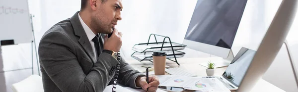 Serious Trader Talking Telephone While Writing Notebook Looking Laptop Banner — Stock Photo, Image