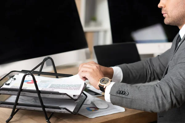 Cropped View Trader Taking Infographics Documents Tray Monitors Blank Screen — Stock Photo, Image