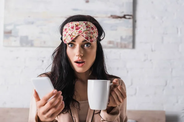 Shocked Young Brunette Woman Sitting Bed Sleep Mask Mug Cocoa — Stock Photo, Image