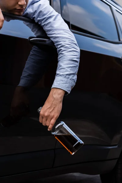 Cropped View Man Holding Bottle Whiskey While Sleeping Car — Stock Photo, Image