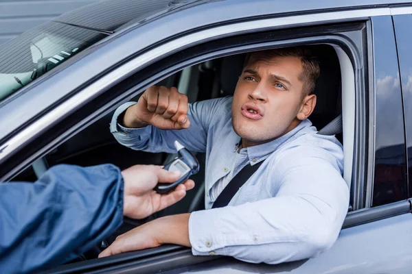 Policeman Giving Breathalyzer Drunk Aggressive Driver Showing Clenched Fist Blurred — Stock Photo, Image