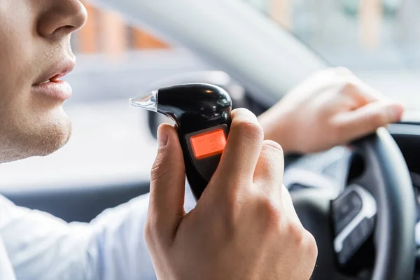 Partial View Man Blowing Breathalyzer While Sitting Car Blurred Background — Stock Photo, Image