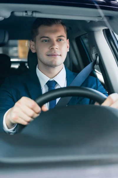 Młody Biznesmen Garniturze Jazdy Auto Zamazanym Pierwszym Planie — Zdjęcie stockowe