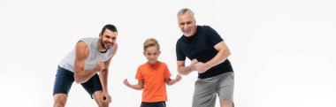kid with father and granddad in sportswear smiling at camera while demonstrating strengths isolated on white, banner clipart