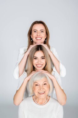 three generation of happy women isolated on grey clipart