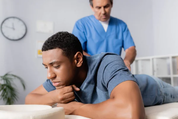 Middle Aged Chiropractor Working Young African American Patient Massage Table — Stock Photo, Image