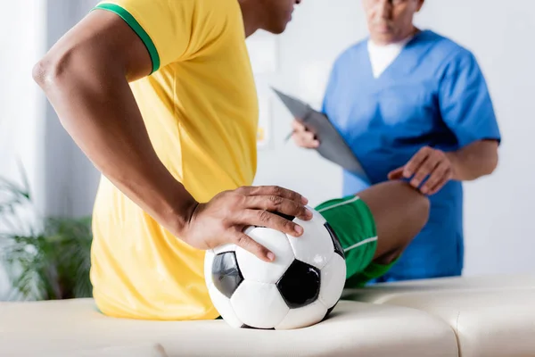 Vista Cortada Jogador Futebol Afro Americano Ferido Sentado Com Bola — Fotografia de Stock